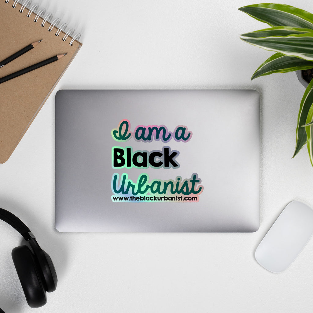 A holographic sticker taking up the top of a silver laptop screen