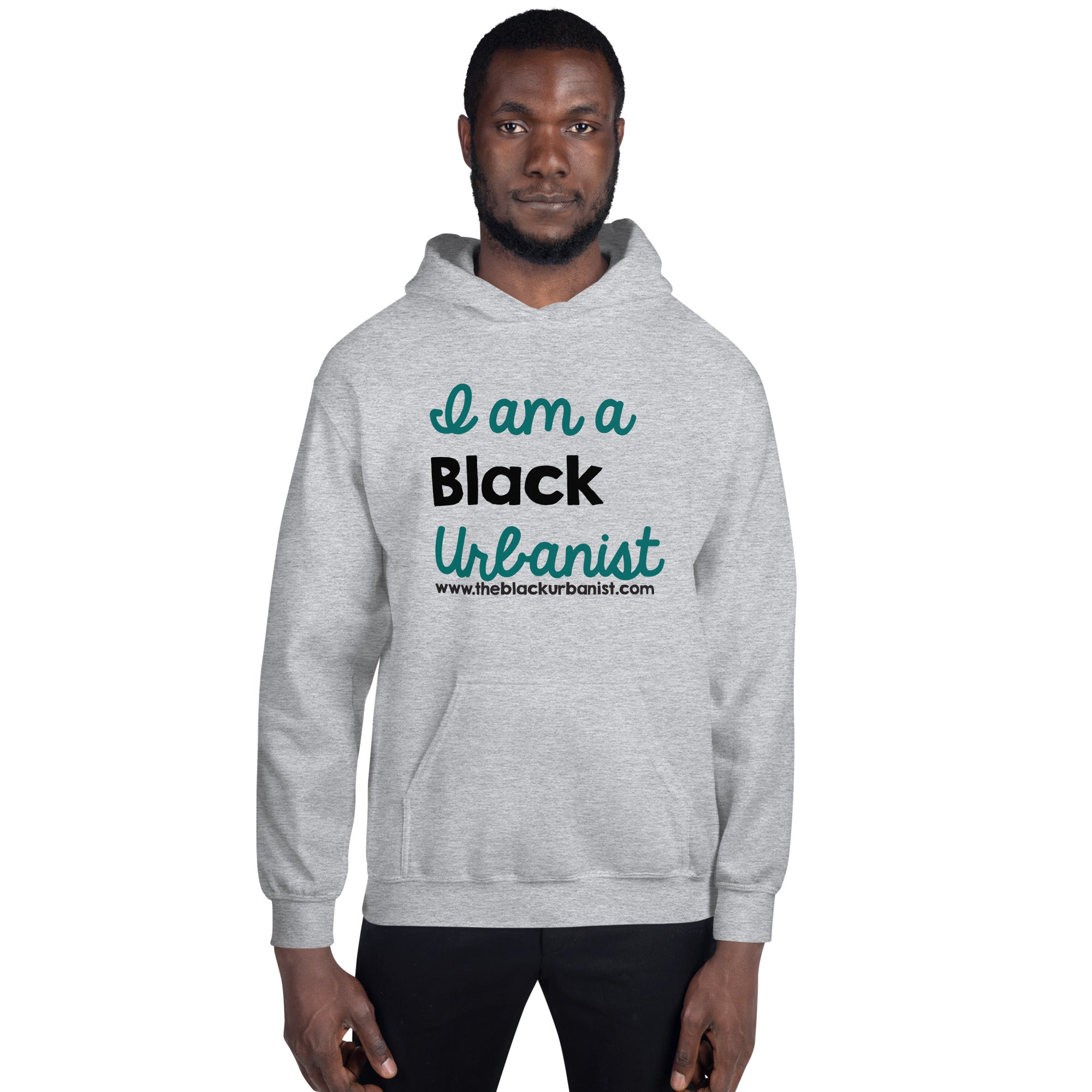 Black man wearing a grey hoodie with I am A Black Urbanist printed on the front
